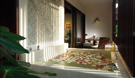 Rasa Deluxe Suite's large semi-outdoor jacuzzi overlooking the lush greenery and Ferringhi beach
